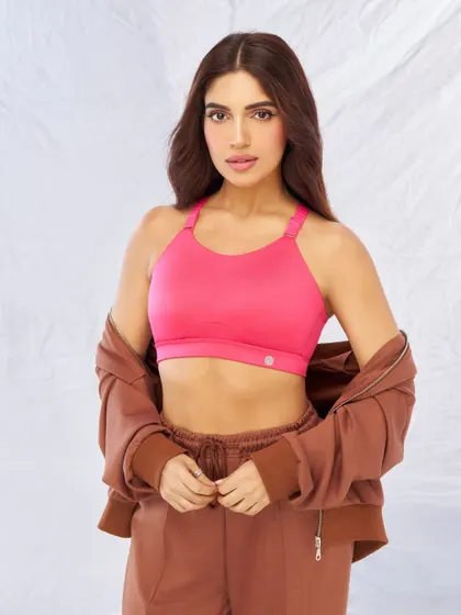 This look showcases the athletic side of the Nykd by Nykaa collection. I paired a vibrant pink sports bra with a comfortable brown tracksuit to create a stylish athleisure look, perfect for demonstrating the product's function and fashion appeal.