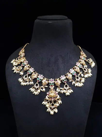 A captivating necklace with multi-colored stones and pearl clusters. This piece is perfect for adding a touch of grace to your festive wear.