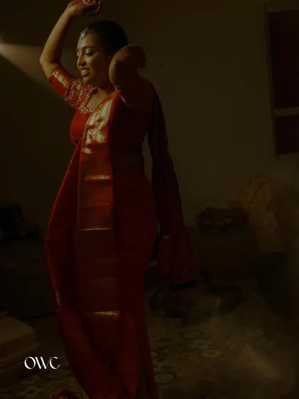 A candid moment of the bride dancing, her silhouette captured against a soft light.