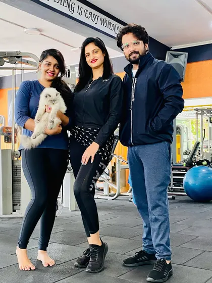 A friendly moment in the gym with clients. Even our furry friends sometimes make an appearance to boost morale.