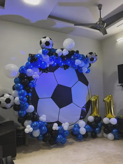 The football backdrop lit up with a cool blue light, adding to the atmosphere of the party.