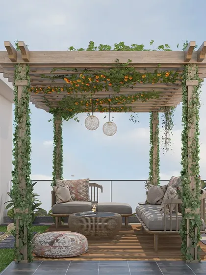A beautiful balcony design featuring a wooden pergola adorned with flowering vines, creating a charming and shaded seating area.