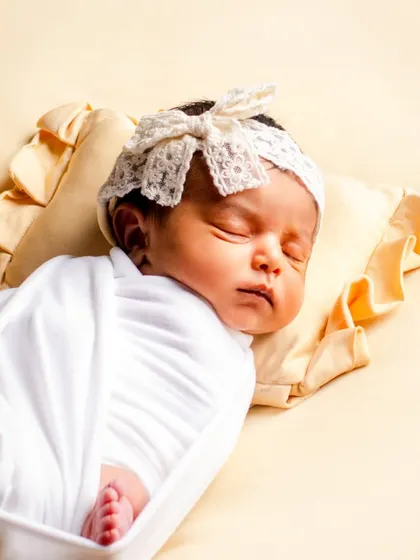 A peaceful, sleeping baby is a beautiful sight. We specialize in safe and comfortable swaddling techniques to keep your newborn snug and content, allowing us to capture these serene moments.