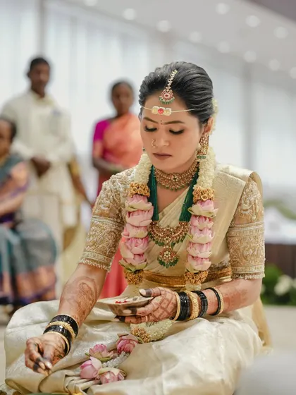 My lovely bride Harshitha during her muhurtham ceremony, wearing a classic off-white silk saree with a heavily embroidered golden blouse.