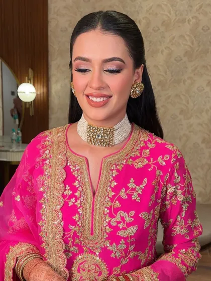 The soft pink tones and shimmering eyeshadow are on full display here. This look is perfect for a pre-wedding puja or family gathering.