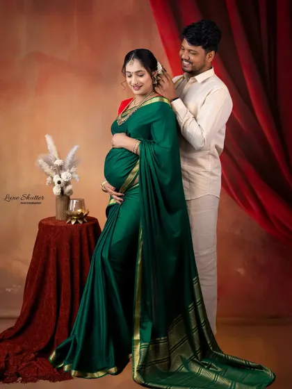 A loving couple's portrait in traditional attire. The husband gently places flowers in his wife's hair, a sweet and intimate gesture that I love to capture.
