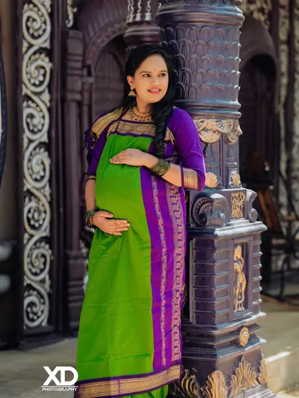 A classic solo portrait of the mother-to-be, her hand on her hip, exuding confidence and joy.