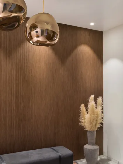 The entrance lobby at our Bayview project features a wall clad in ribbed walnut veneer. The texture of the wood, combined with the warm glow of the pendant lights, creates a sophisticated and welcoming first impression.