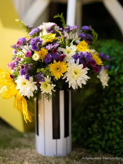 A beautiful floral arrangement in a custom piano-key vase, bringing together the musical theme with the freshness of nature.