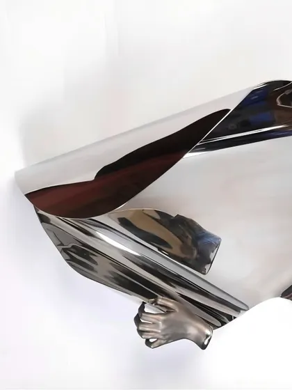Another angle of "The Power of Being," showing the hand grasping the fluid metal form.