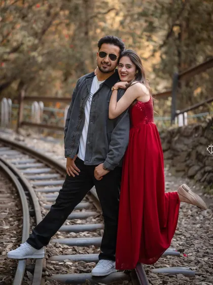 A fun and stylish pose on the tracks. This image shows how we can blend playful energy with the classic backdrop of the Shimla hills.