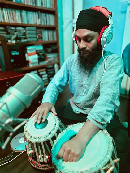 Focused on the intricate bols (strokes) during the kirtan recording. Each note is played with devotion and respect for the composition.