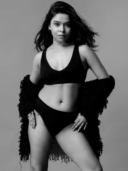 A black and white version of a standing pose, creating a powerful and classic image.