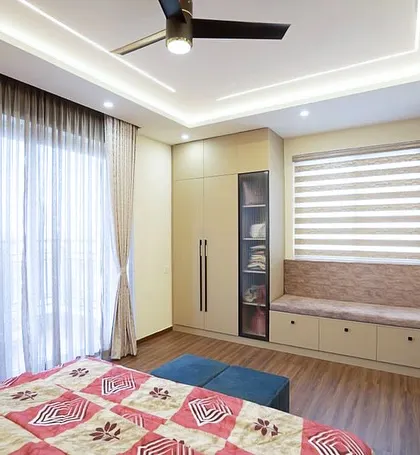 In this bedroom, I incorporated a cushioned window seat with built-in drawers into the wardrobe unit. This not only provides extra storage but also creates a perfect, sunlit spot for reading or relaxing.