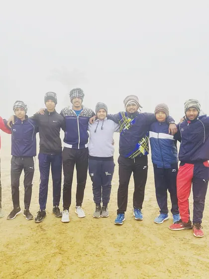 Training continues no matter the weather. The team huddles together for a photo during a cold and foggy winter morning practice.