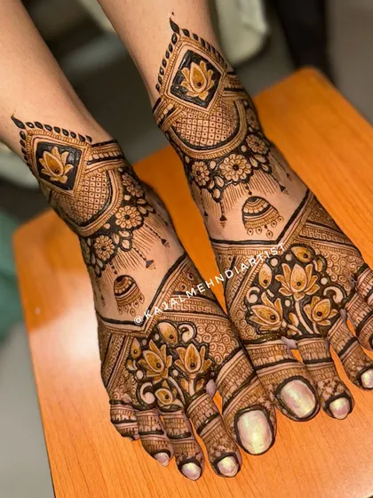 An angled view of the bridal leg design with jhumkas and lotuses.