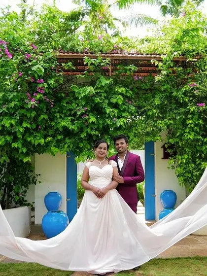 This outdoor shot showcases the dramatic flying trails of our white gown, creating a beautiful contrast with the lush green background.