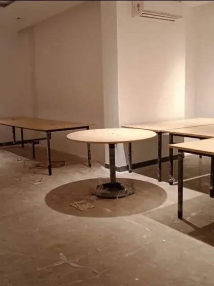 A look at our office tables being set up in a commercial space. This shows the raw, functional furniture before the office is fully decorated.