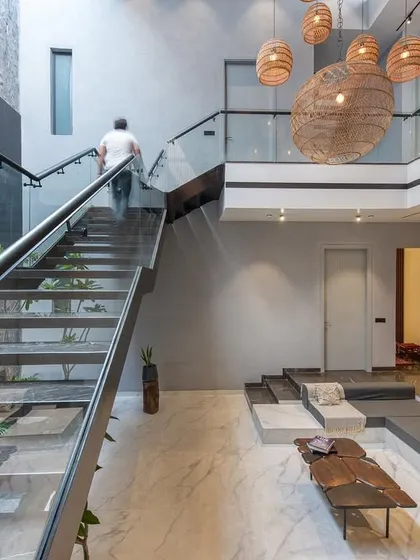 A view up the staircase at Casa Acentuada, demonstrating how we design for movement and experience. The glass railing ensures unobstructed views across the open-plan space.