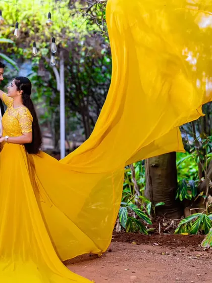 A vibrant yellow gown with an embellished bodice, perfect for a sunny outdoor photoshoot. The long trail adds movement and elegance to the couple's portraits.