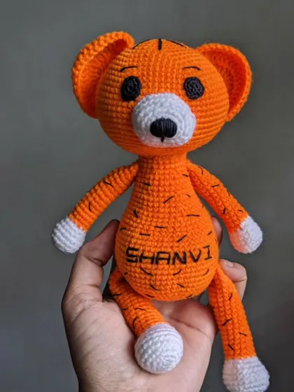 A full-body view of the personalized tiger toy, showing its long limbs and striped details.