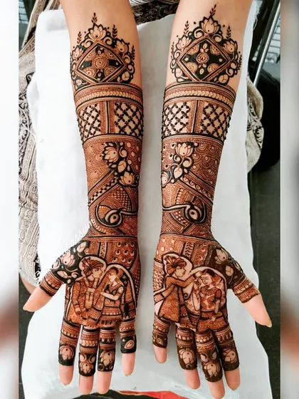 This intricate design features a couple's portrait on the palms, with bold, symmetrical patterns on the forearms. The use of checkerboard and floral motifs adds visual interest and complexity.