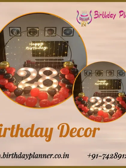 This intimate birthday decor for a 28th celebration features a ring-shaped frame with red and black balloons, illuminated marquee numbers, and a neon sign, perfect for a smaller gathering or home party.