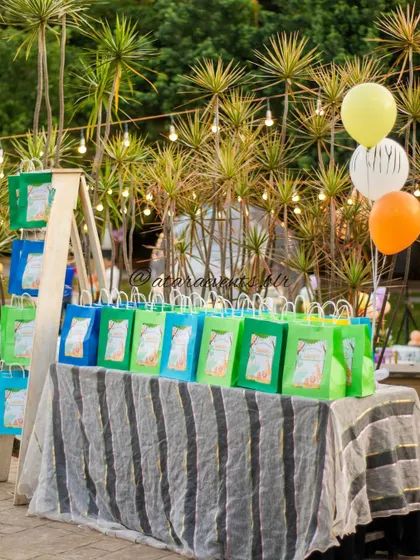 Themed party favor bags are displayed on a rustic table, ready for guests to take home a piece of the jungle adventure.
