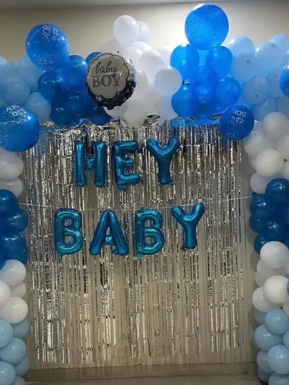 This is the same popular 'Hey Baby' setup for welcoming a newborn boy. The combination of the shimmer curtain and the full balloon arch makes for a great photo background at home.