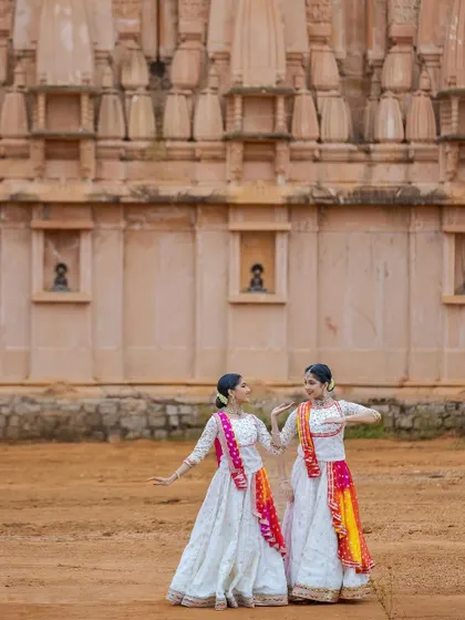 A static pose showing the beautiful lines and symmetry we create together. Our matching costumes with contrasting dupattas add to the visual harmony of the performance.