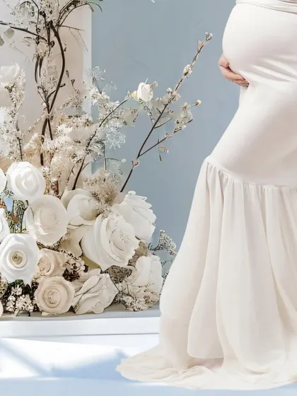 A detail shot focusing on the baby bump, set against a stunning backdrop of white flowers. This artistic composition highlights the beauty of pregnancy in a sophisticated way.