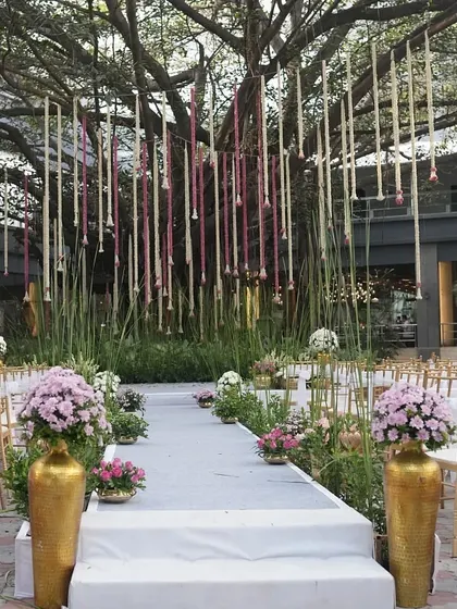 A wider view of the modern wedding setup, showing the clean lines of the aisle and the elegant guest seating.