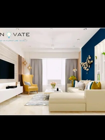 A bright and airy living room with a large L-shaped sofa and a floating white TV console. The blue accent wall and decorative elements add a pop of color and personality.