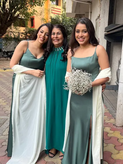 A beautiful photo of two bridesmaids with a family member. It's always a joy to get the whole family glammed up.