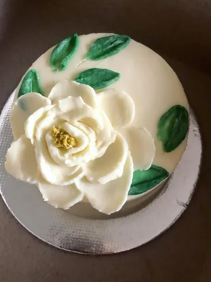 This cutie is an old-fashioned sponge cake with a simple lime buttercream, my personal favorite flavor! The large, hand-painted white flower makes a simple cake feel extra special.
