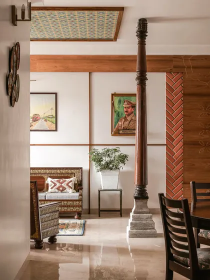 This space shows how we integrate structural elements like this traditional wooden pillar into the design. It acts as a natural divider and a piece of history within a modern living area.