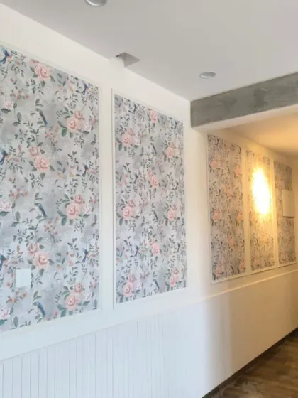 A classic and elegant look achieved by installing floral wallpaper within wall panels. This technique adds texture and definition, turning a simple hallway into a sophisticated space.