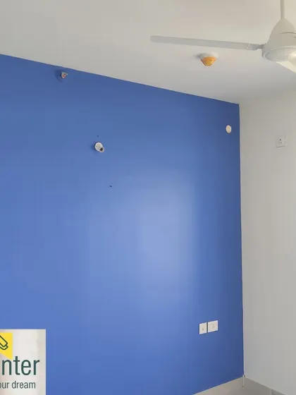 The same periwinkle blue wall, showing the clean contrast with the white ceiling.