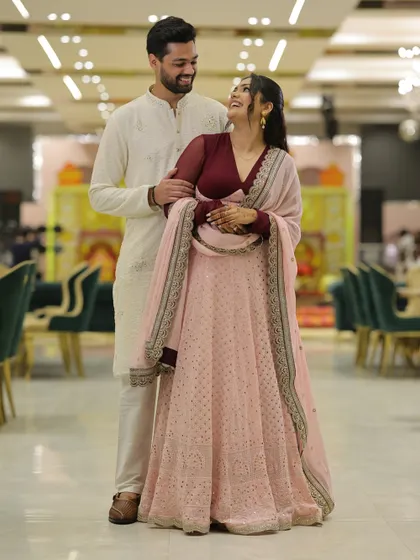 A candid, happy moment with my fiancé from our roka. My pink and maroon lehenga was chosen to feel celebratory and personal.