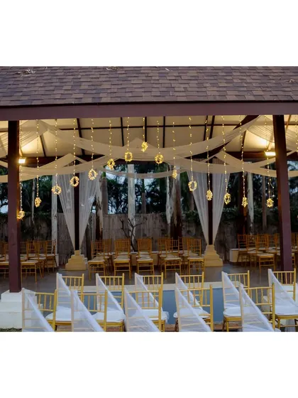 The Sangeet decor features disco balls, lush foliage, and a symphony of lights, turning the venue into an enchanted wonderland.