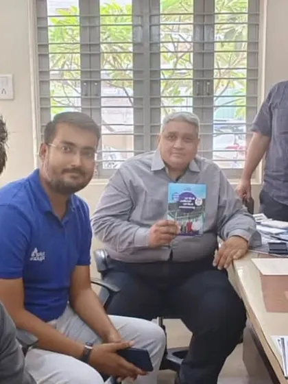 Our team with customers in an office, holding our solar guide. We provide tailored solutions for every need.