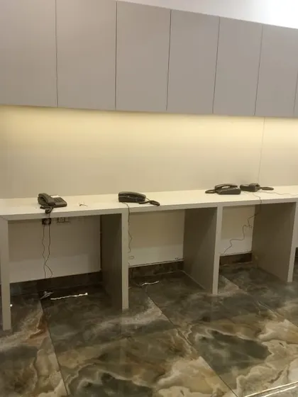 A long office desk with multiple telephone handsets installed, ensuring seamless communication across the team.