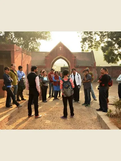 A group stands at the entrance of Nicholson Cemetery at sunset. Here, I introduce the complex character of John Nicholson and the role he played in the siege of Delhi.