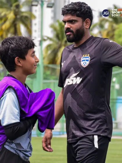 A coach from our Bengaluru FC partnership program offers one-on-one guidance to a U-13 player. This personalized attention is key to developing young talent.