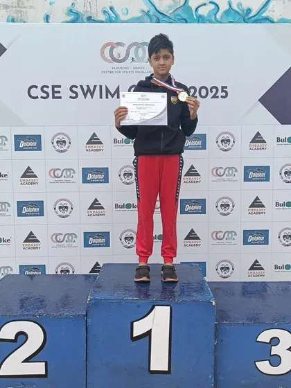 Shaswat Singh on the winner's podium after securing gold in the 50m and 100m Backstroke events at the CSE Swimming Competition.