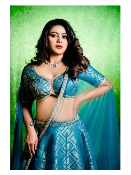 Another powerful shot of the teal blue lehenga, showing its beautiful texture and sheen. This outfit is sure to make you feel confident and elegant.