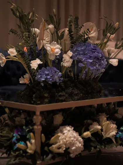 This centerpiece for a lounge seating area features a rich mix of textures, from the moss base to the delicate petals of anthuriums and hydrangeas. It’s a small detail that adds to the overall sense of curated luxury in our event design.