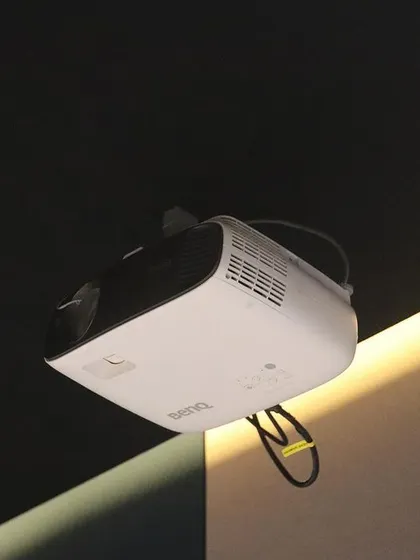 A ceiling-mounted BenQ projector, another excellent option I use to provide clients with high-quality, reliable 4K projection.