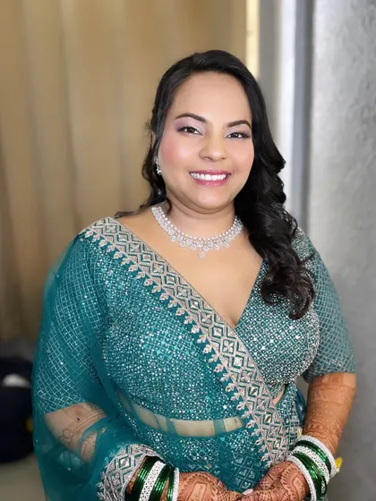 My beautiful bride Priya, ready for her reception. She wore a stunning teal lehenga, and I created a soft glam makeup look with a focus on radiant skin to complement it.
