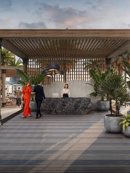 The main entrance path to the Fairmont outdoor lounge, framed by a wooden pergola and lush hedges, setting a luxurious tone upon arrival.